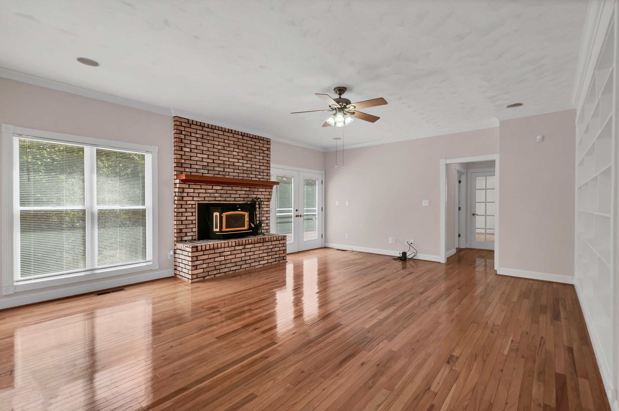 1400 Slaydenwood Road Cumberland Furnace, TN 37051 - Photo 9 of 58 a view of an empty room with wooden floor fireplace and a window