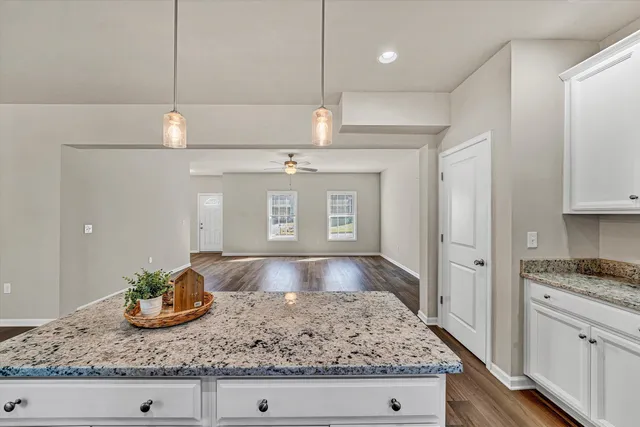 a kitchen with stainless steel appliances granite countertop a sink a stove and cabinets