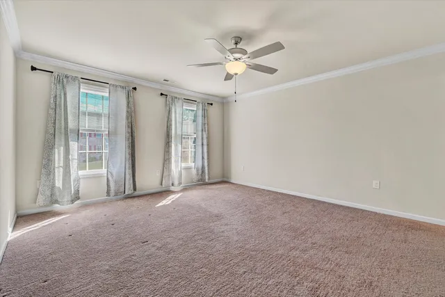 a view of a livingroom with a ceiling fan and window