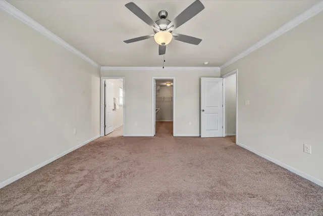 a view of an empty room with a ceiling fan