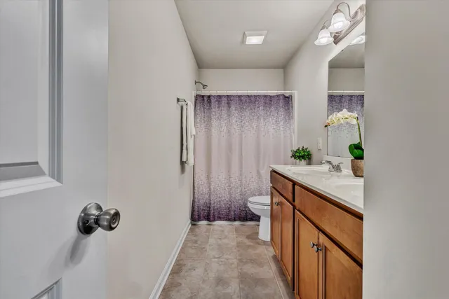 a hallway with sink and mirror