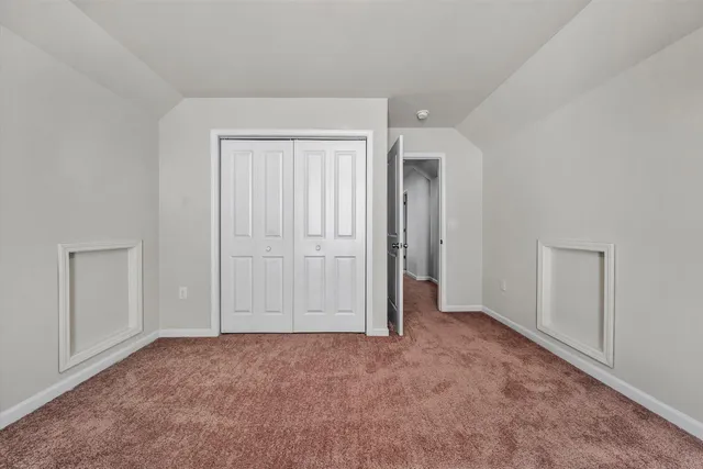 an empty room with closet area
