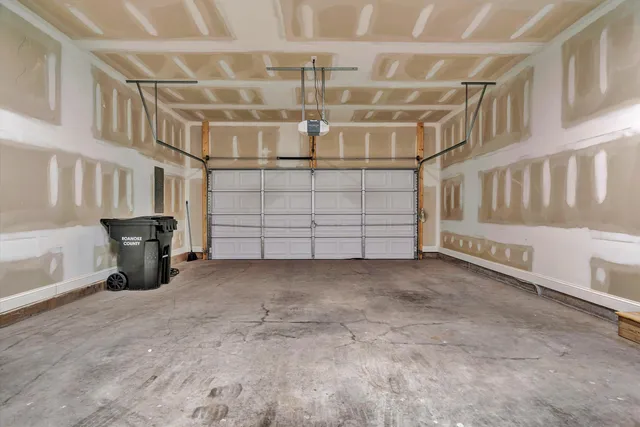 a view of a garage with white cabinets