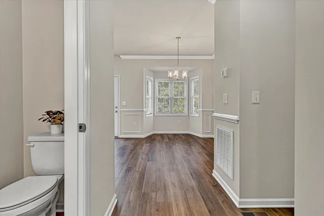 a view of bathroom with a hardwood floor and a ceiling fan