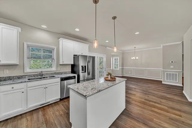 a open kitchen with stainless steel appliances granite countertop a sink a refrigerator and a stove