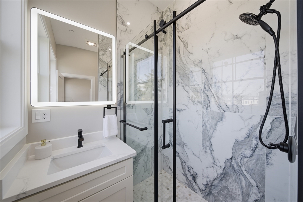 174 Walnut Street, Unit 3 Somerville, MA 02145 - Photo 11 of 38 a bathroom with a sink vanity and shower