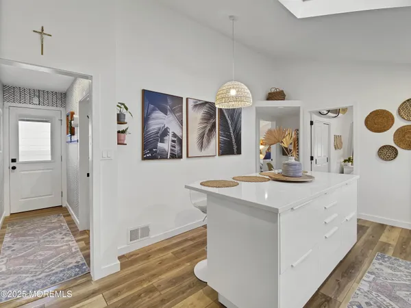 a view of a kitchen with a sink and refrigerator