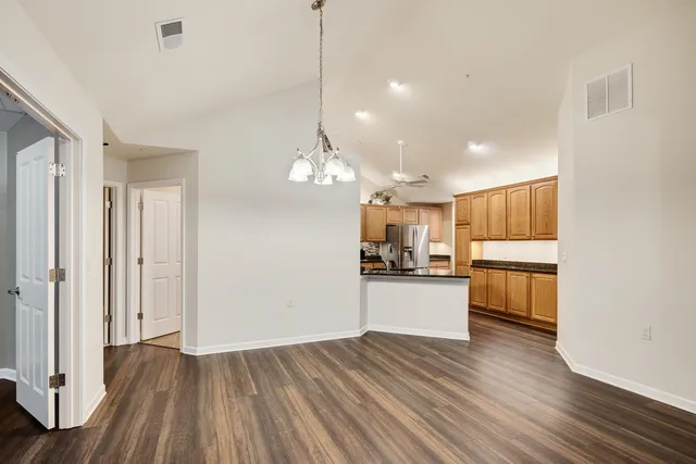 a kitchen with a refrigerator and a stove top oven