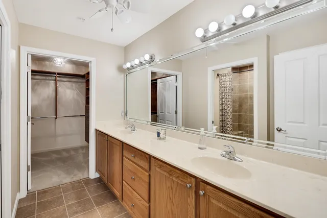 a bathroom with double vanity sinks and a mirror