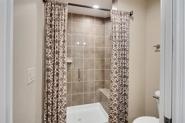 a bathroom with a shower and a toilet