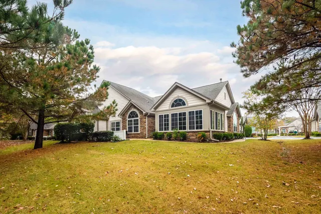 a front view of house with yard and green space