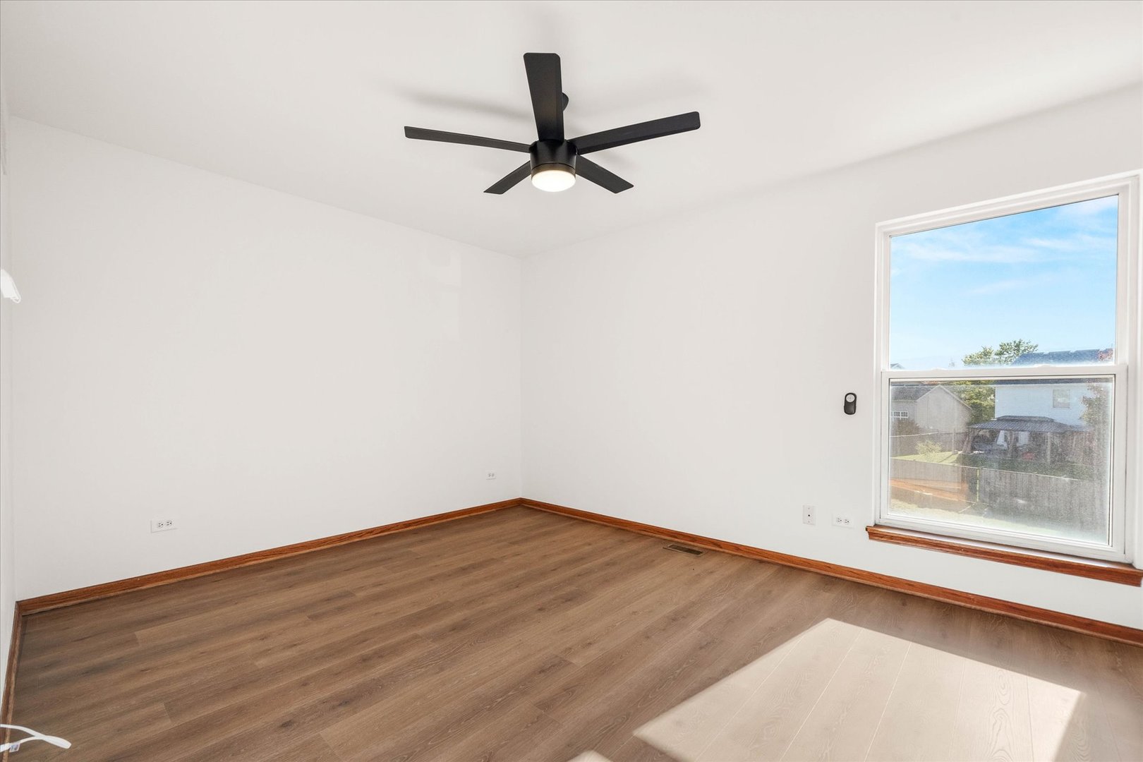 2152 Brayton Place Plainfield, IL 60586 - Photo 14 of 28 an empty room with wooden floor and windows