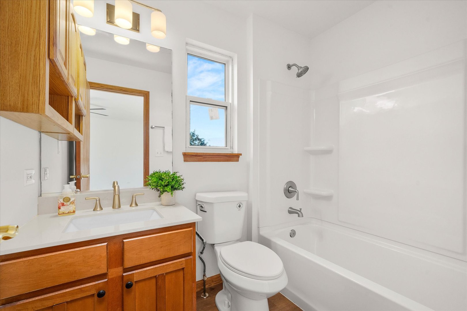 2152 Brayton Place Plainfield, IL 60586 - Photo 16 of 28 a bathroom with a granite countertop toilet a sink and a bathtub