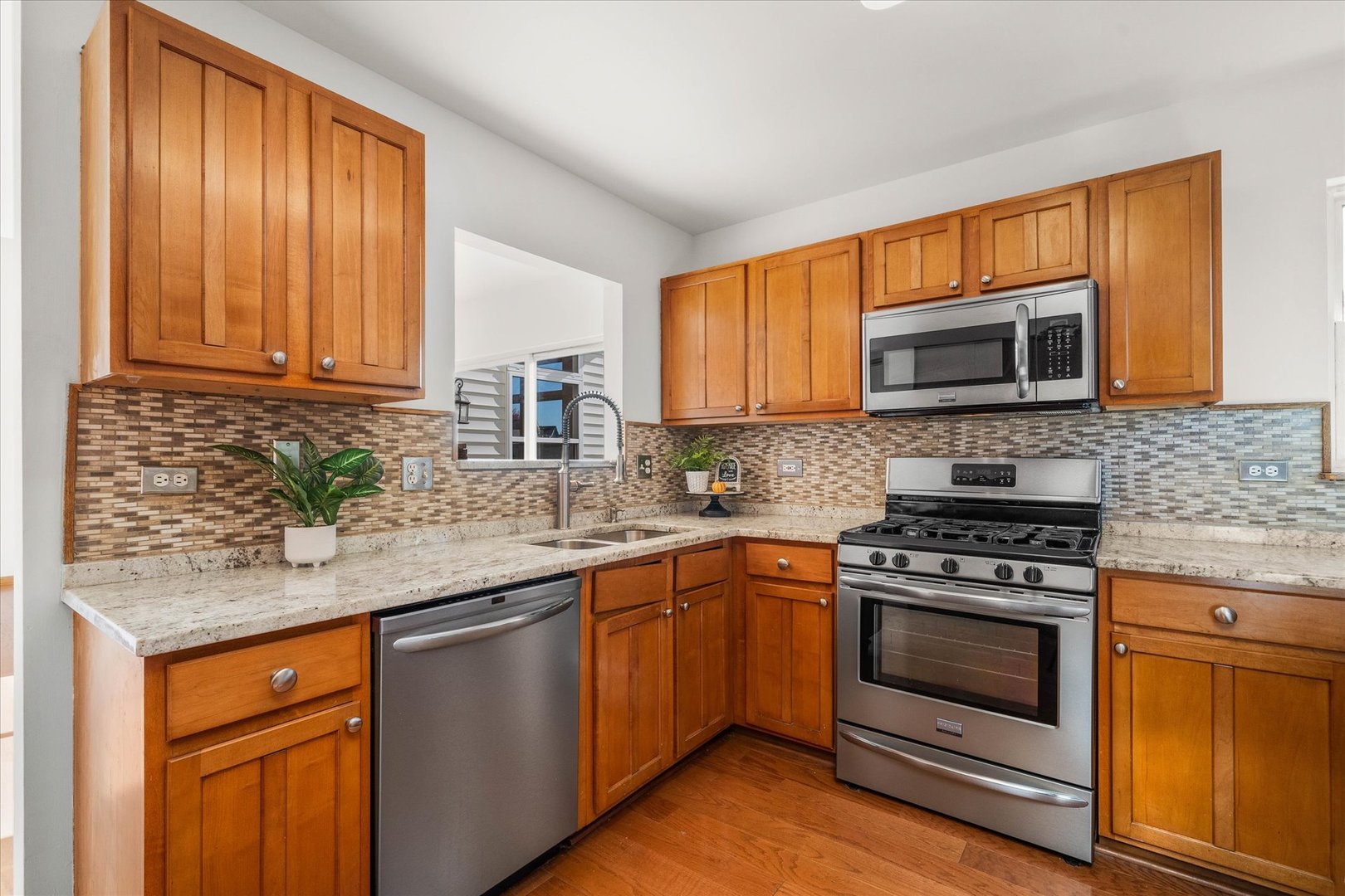 2152 Brayton Place Plainfield, IL 60586 - Photo 9 of 28 a kitchen with stainless steel appliances granite countertop wooden cabinets stove and a granite counter top