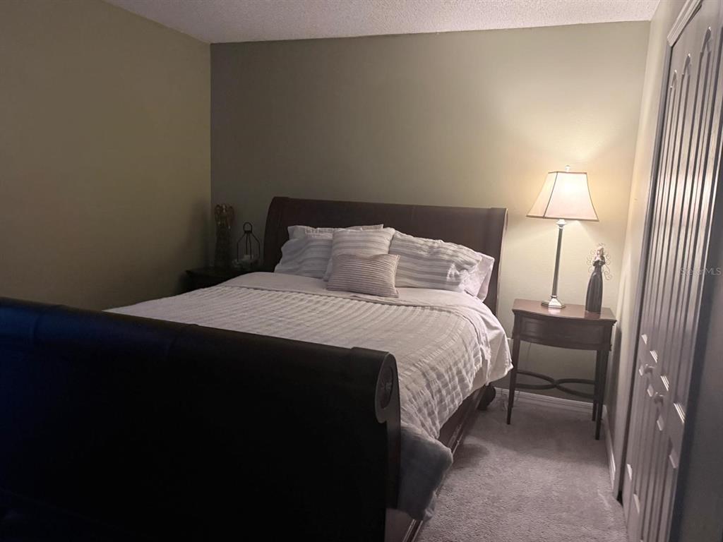 609 Prince Lane Oviedo, FL 32765 - Photo 14 of 20 a bedroom with a bed and a lamp