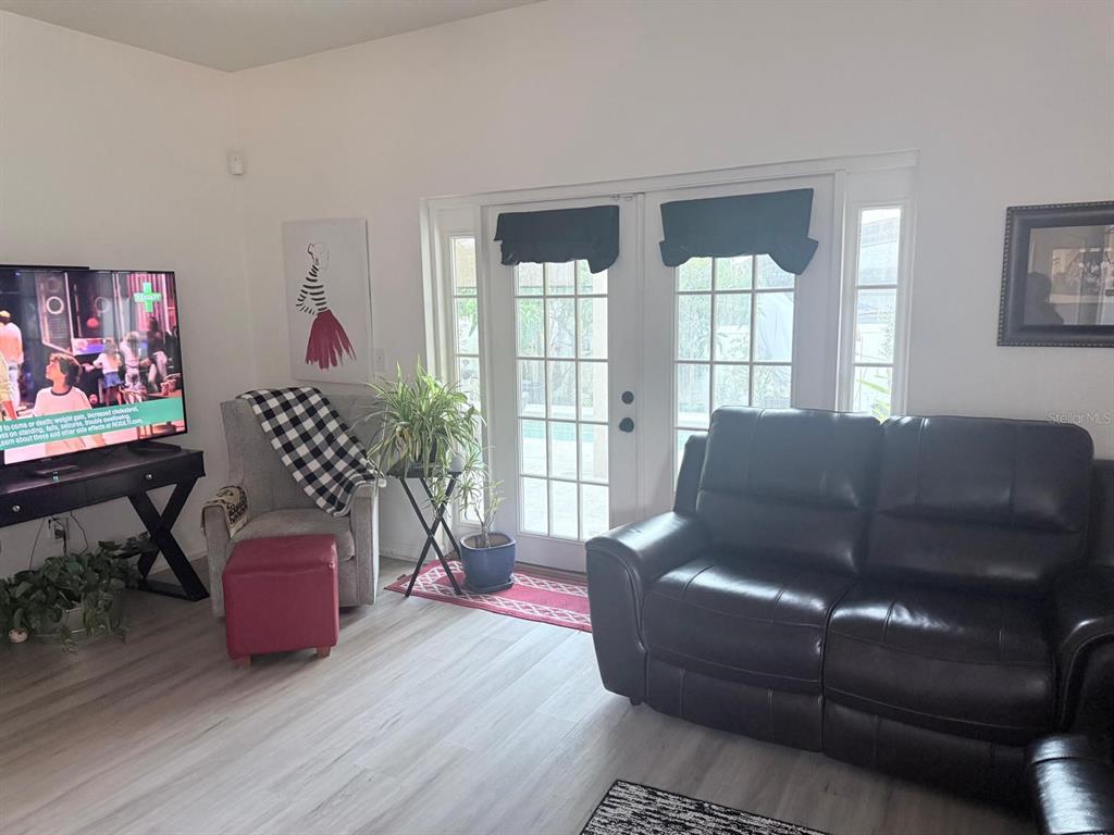 609 Prince Lane Oviedo, FL 32765 - Photo 8 of 20 a living room with furniture and a wooden floor