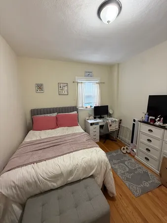 a bedroom with a bed and a television