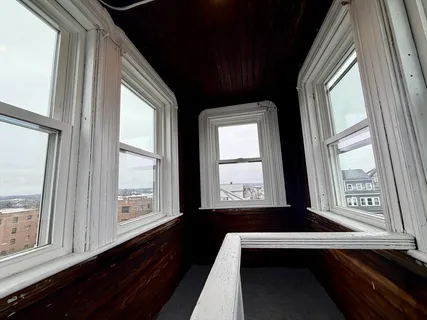 a view of two windows in an empty room