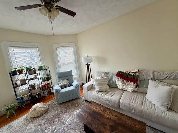 a living room with furniture and a chandelier