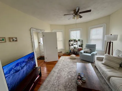 a living room with furniture and a chandelier