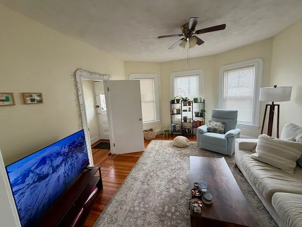 a living room with furniture and a chandelier