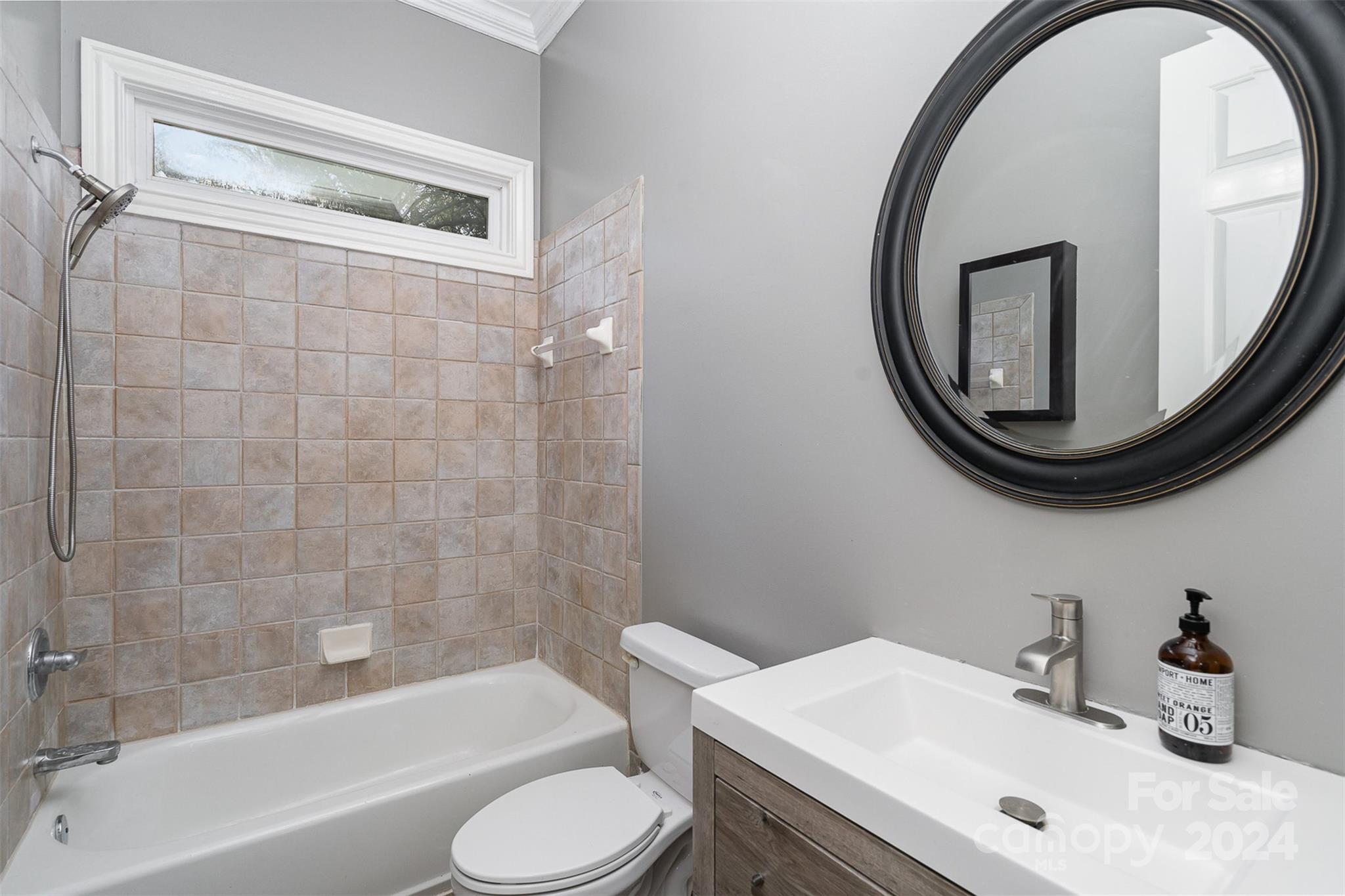 128 Mayfair Road Mooresville, NC 28117 - Photo 13 of 35 a bathroom with a sink a toilet and a mirror