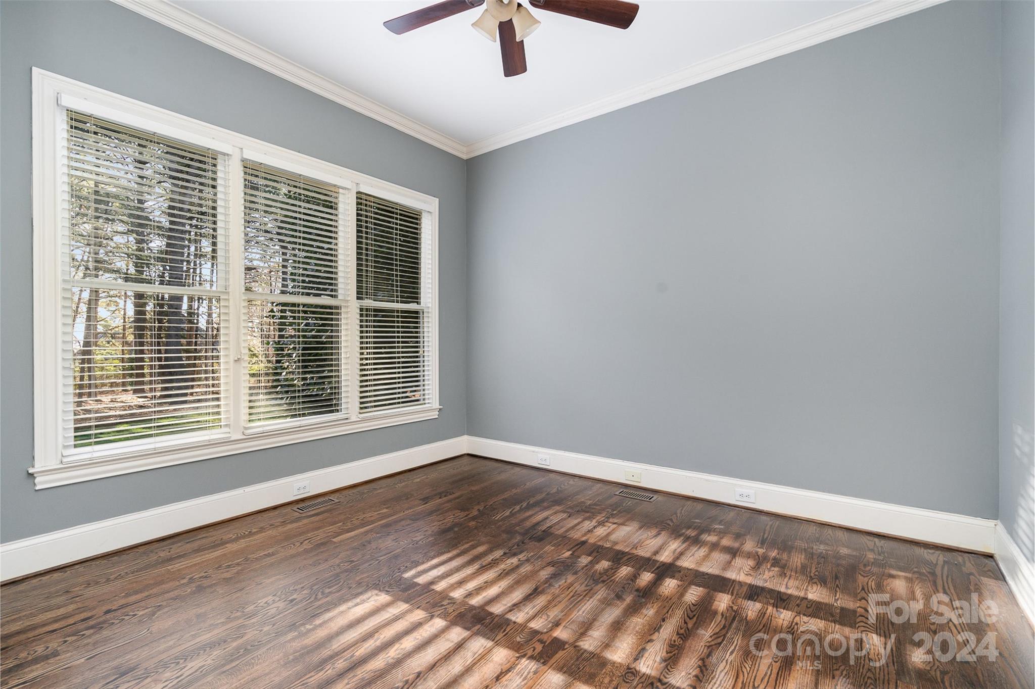 128 Mayfair Road Mooresville, NC 28117 - Photo 14 of 35 a view of an empty room with a window and wooden floor