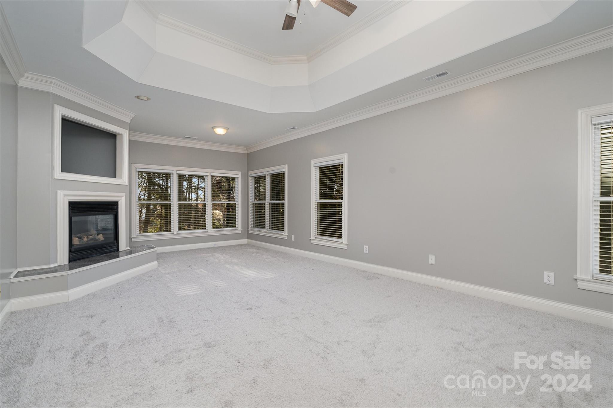 128 Mayfair Road Mooresville, NC 28117 - Photo 16 of 35 a view of an empty room with a fireplace and a window