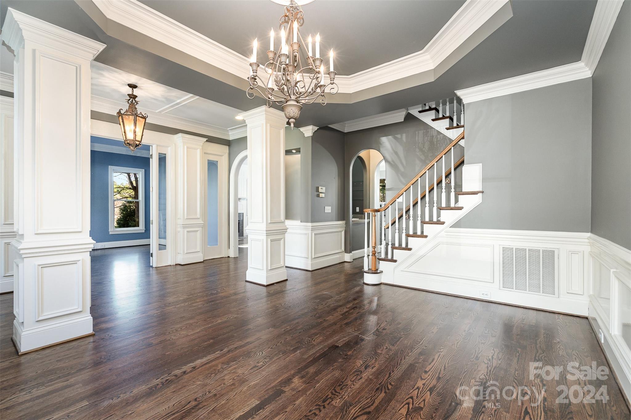 128 Mayfair Road Mooresville, NC 28117 - Photo 5 of 35 a view of a hallway with wooden floor and a chandelier