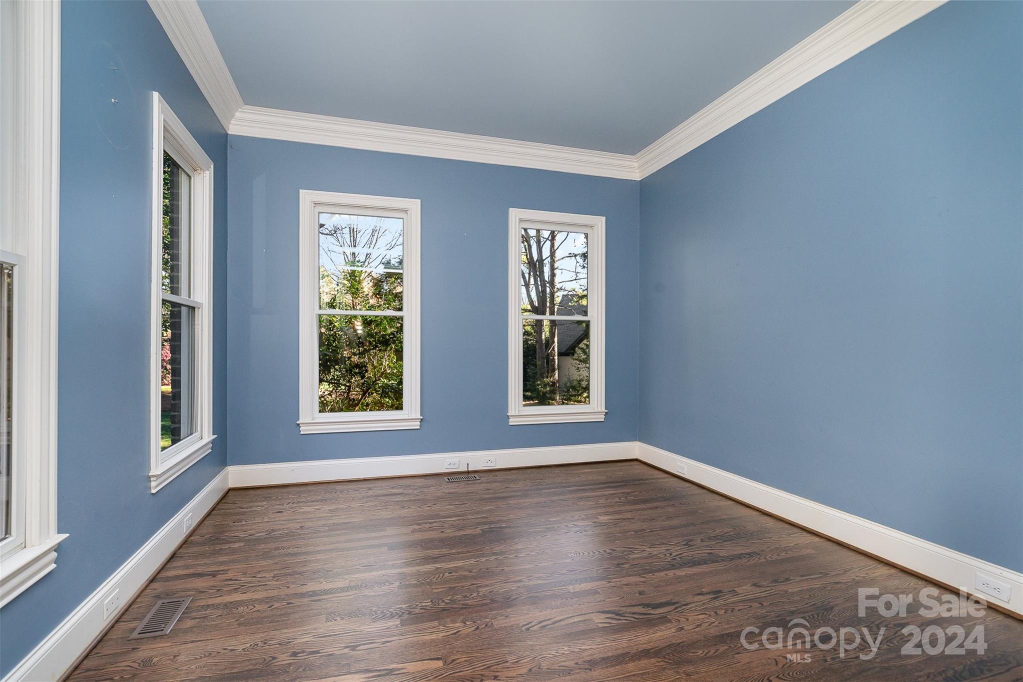 128 Mayfair Road Mooresville, NC 28117 - Photo 6 of 35 a view of an empty room with wooden floor and a window