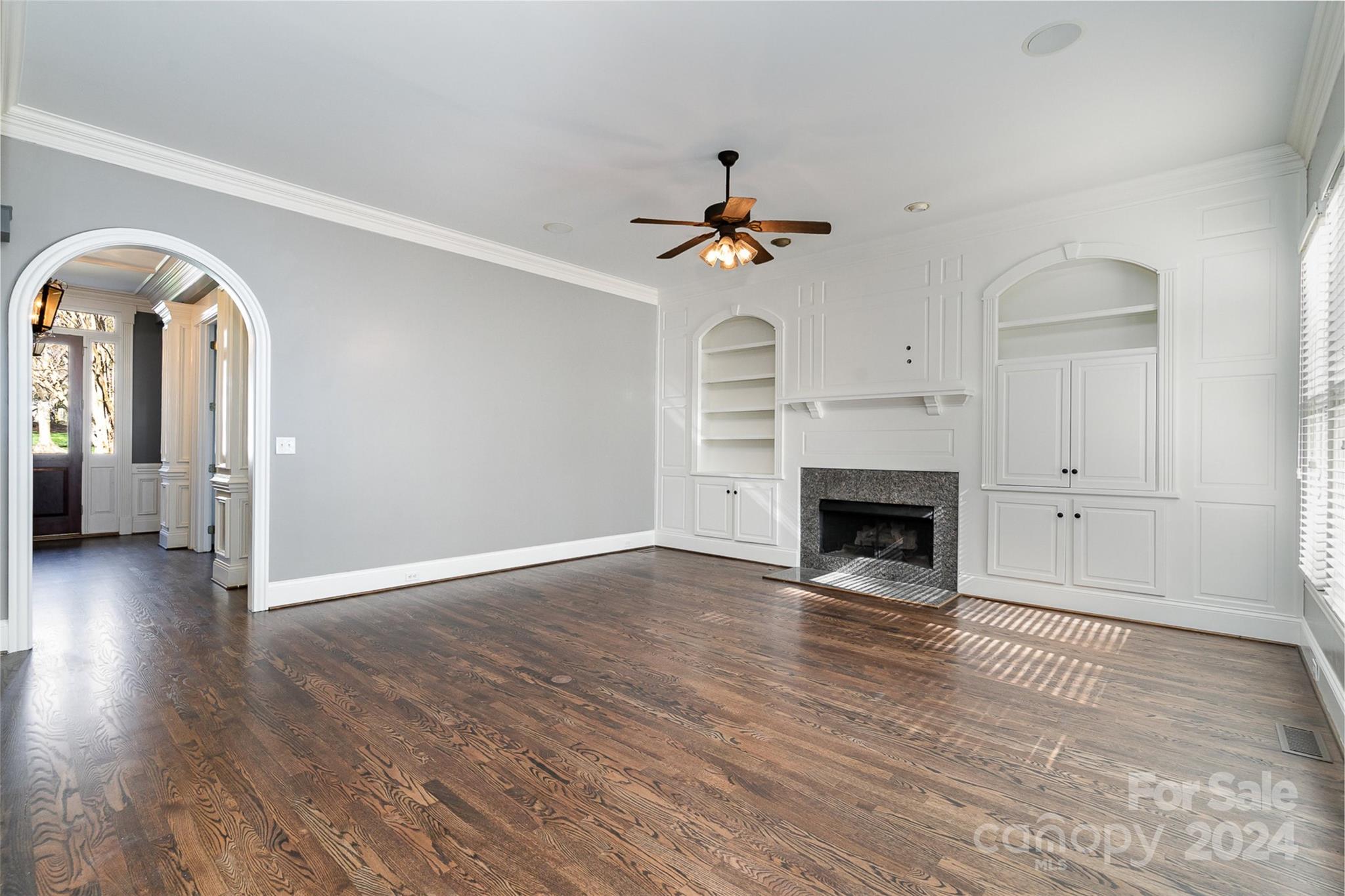128 Mayfair Road Mooresville, NC 28117 - Photo 9 of 35 a view of a livingroom with wooden floor and a fireplace