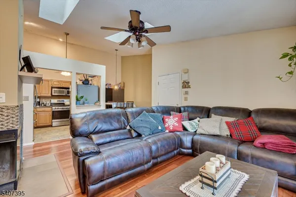 a living room with furniture a ceiling fan and a rug