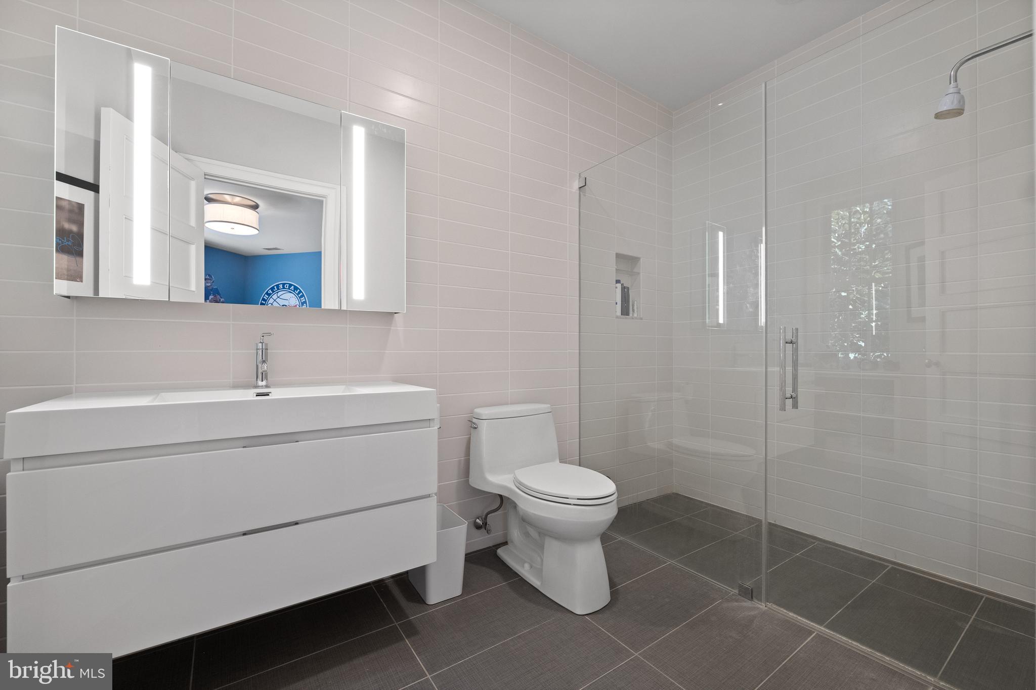 423 North Spring Mill Road Villanova, PA 19085 - Photo 45 of 67 a bathroom with a sink toilet a mirror and shower