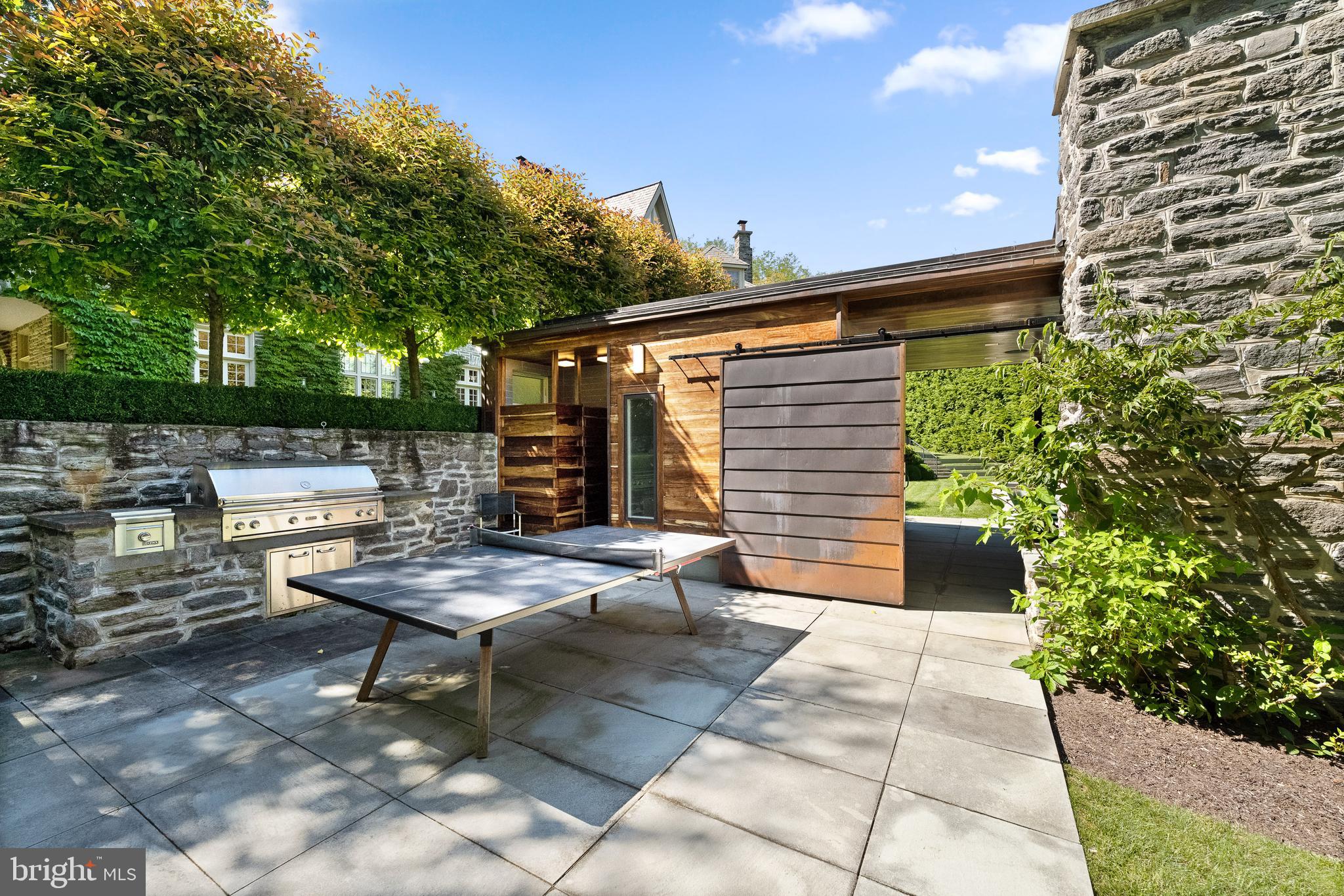 423 North Spring Mill Road Villanova, PA 19085 - Photo 57 of 67 a backyard of a house with outdoor seating