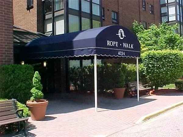 a view of a table with chairs and potted plants