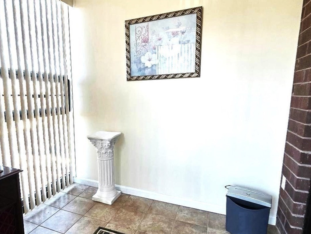 4234 North Main Street, Unit 103 Fall River, MA 02720 - Photo 5 of 10 a picture of a door with a bench