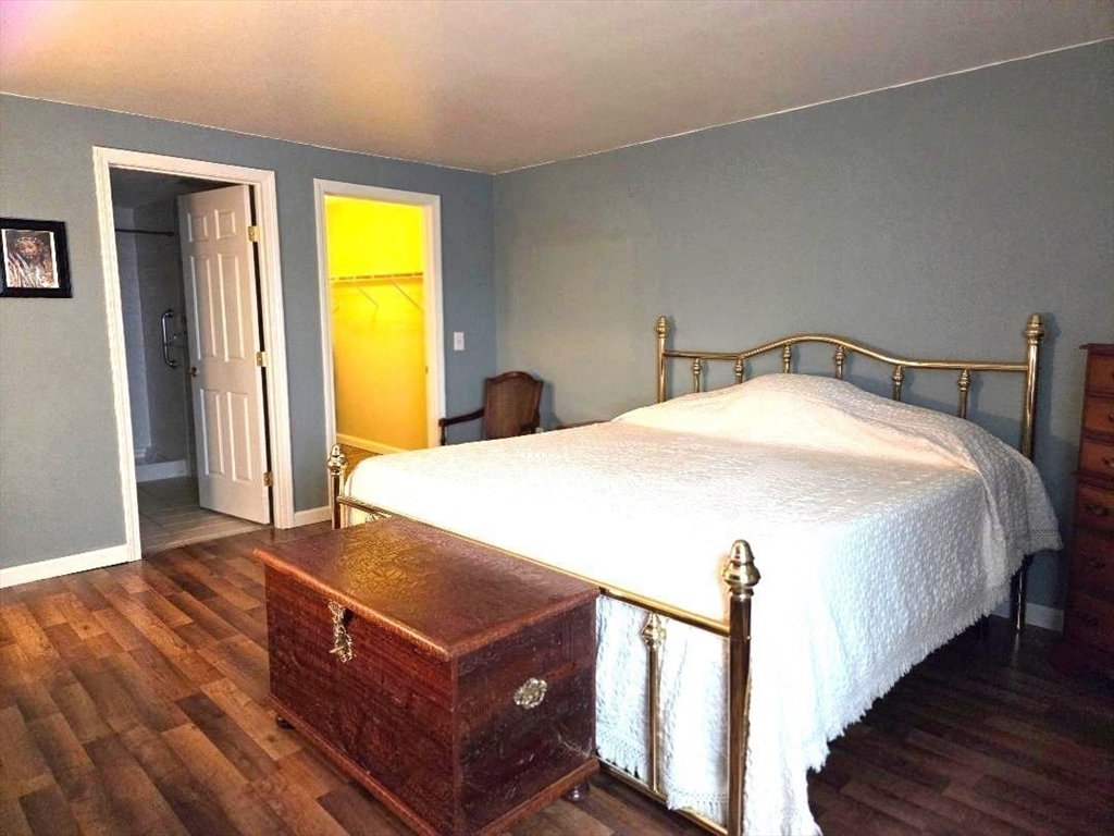 4234 North Main Street, Unit 103 Fall River, MA 02720 - Photo 7 of 10 a bedroom with a bed and wooden floor