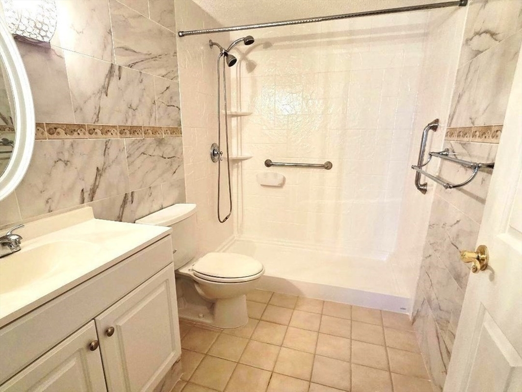 4234 North Main Street, Unit 103 Fall River, MA 02720 - Photo 8 of 10 a bathroom with a shower a toilet and a sink