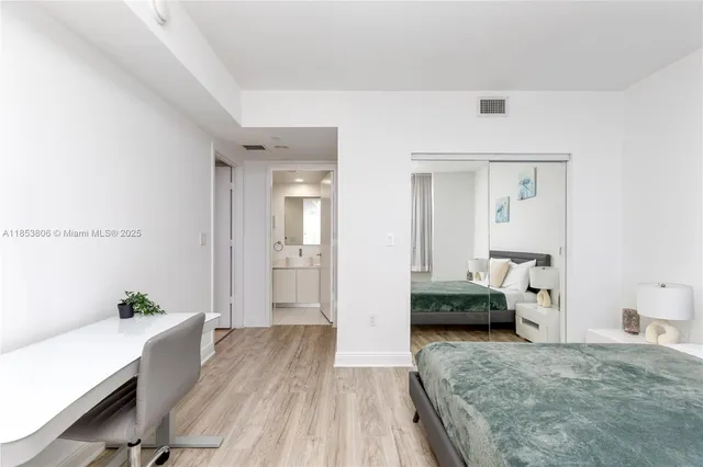 a bedroom with furniture and a large window