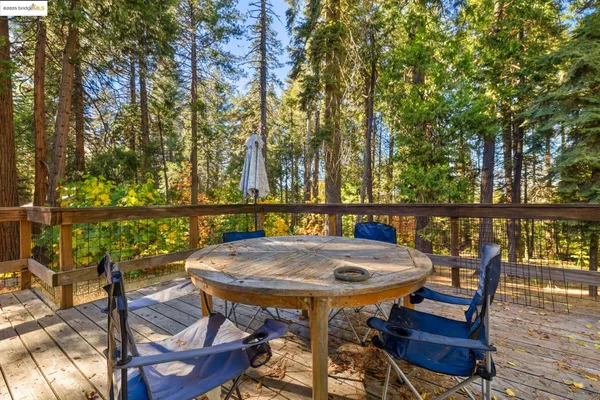 a view of a wooden deck and a backyard