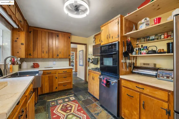 a kitchen with stainless steel appliances granite countertop a sink and cabinets