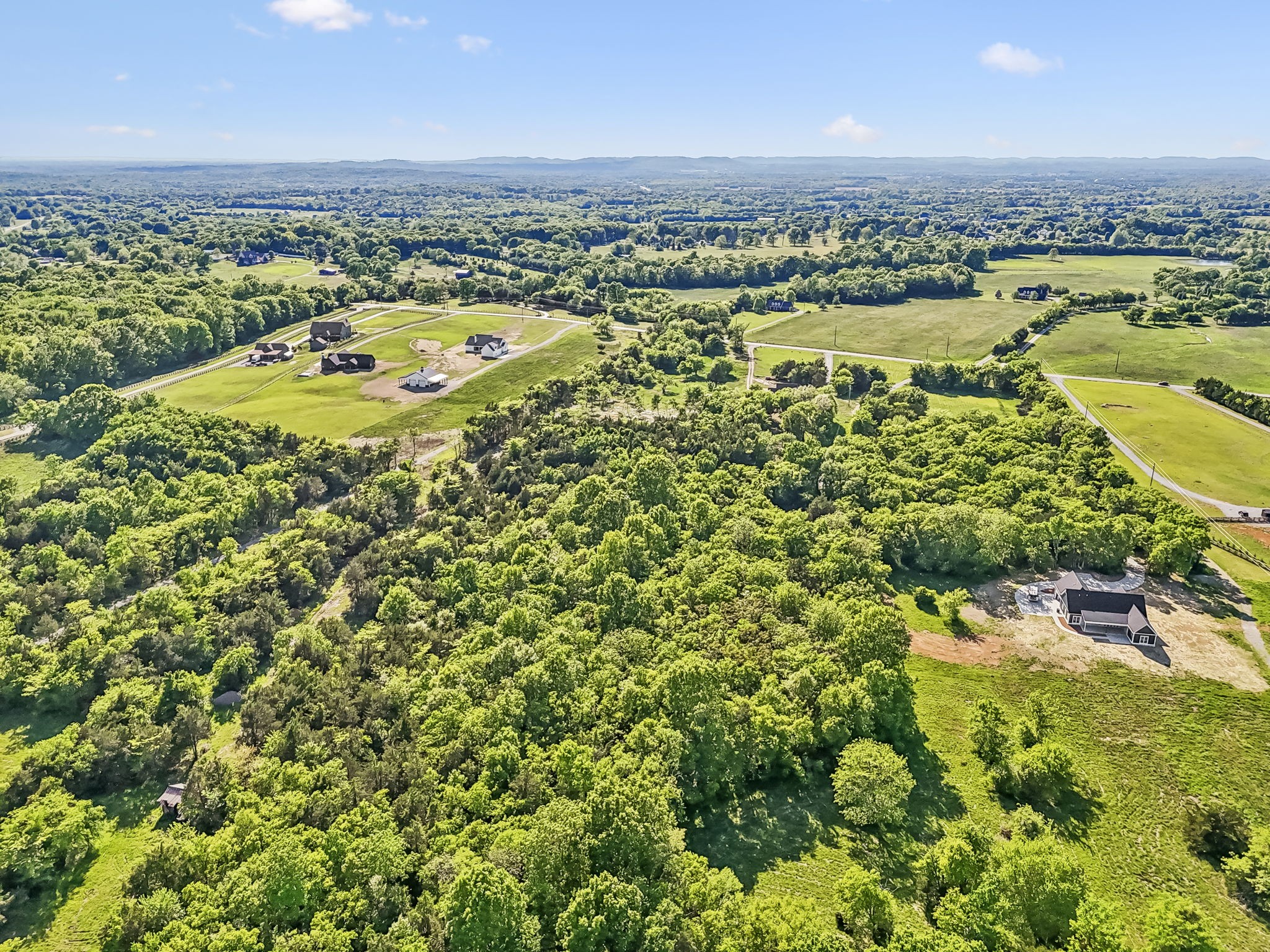 10567 Versailles Road Murfreesboro, TN 37128 - Photo 12 of 25 an aerial view of residential houses with outdoor space and trees