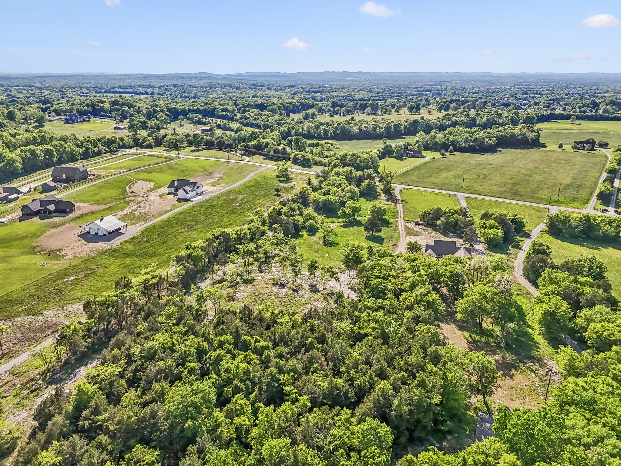 10567 Versailles Road Murfreesboro, TN 37128 - Photo 15 of 25 an aerial view of a city with lots of residential buildings ocean and mountain view in back