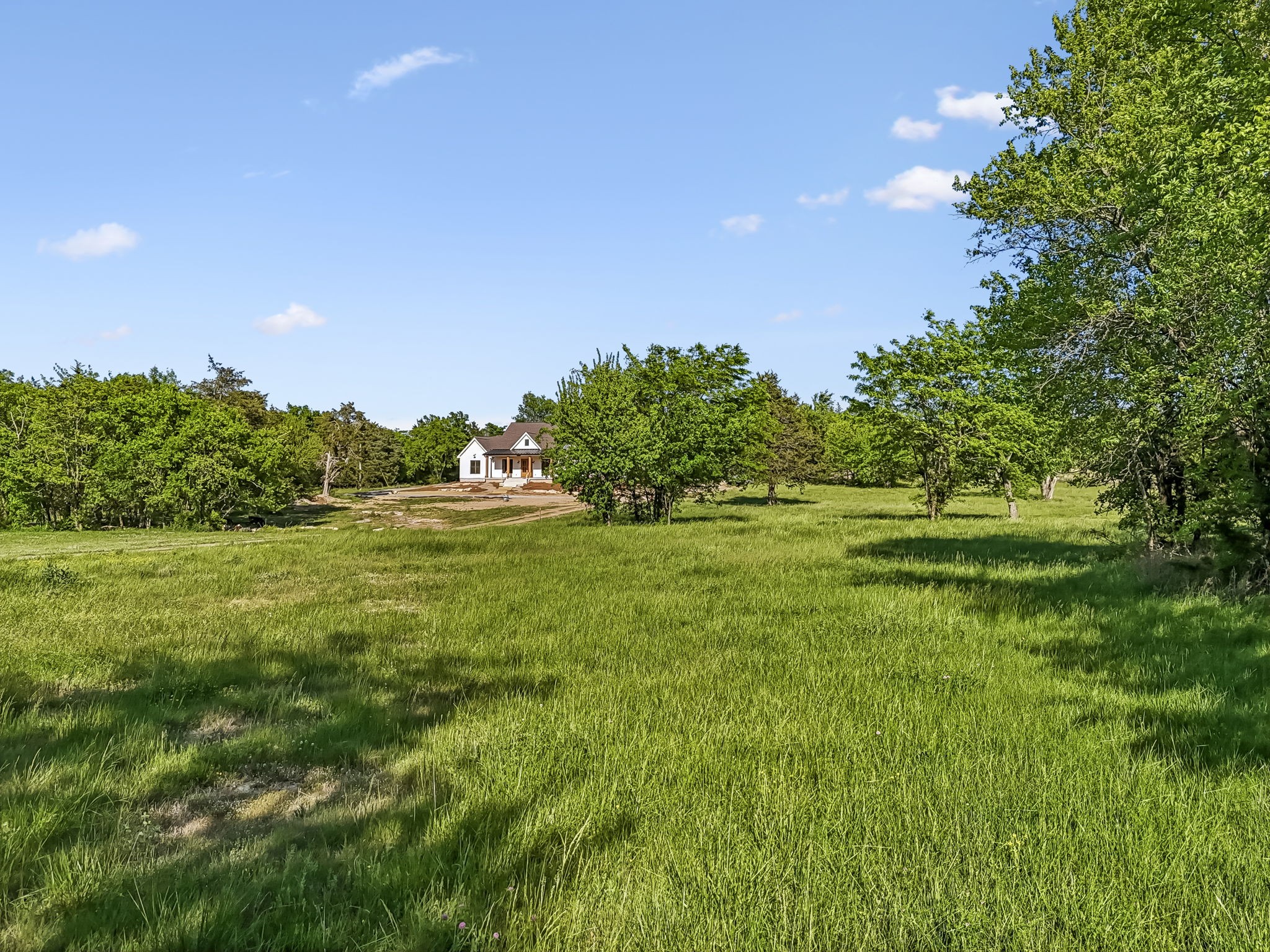 10567 Versailles Road Murfreesboro, TN 37128 - Photo 25 of 25 a backyard of a house with lots of green space and outdoor seating