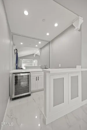 a large kitchen with granite countertop a large counter top stainless steel appliances and cabinets