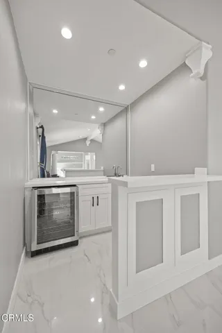 a large kitchen with granite countertop a large counter top stainless steel appliances and cabinets