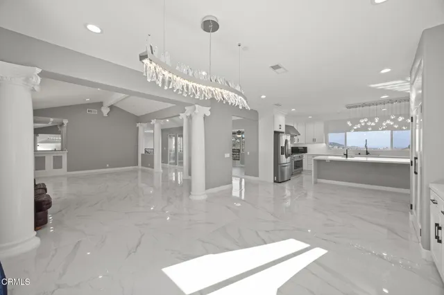 a view of an empty room with a fireplace and a window