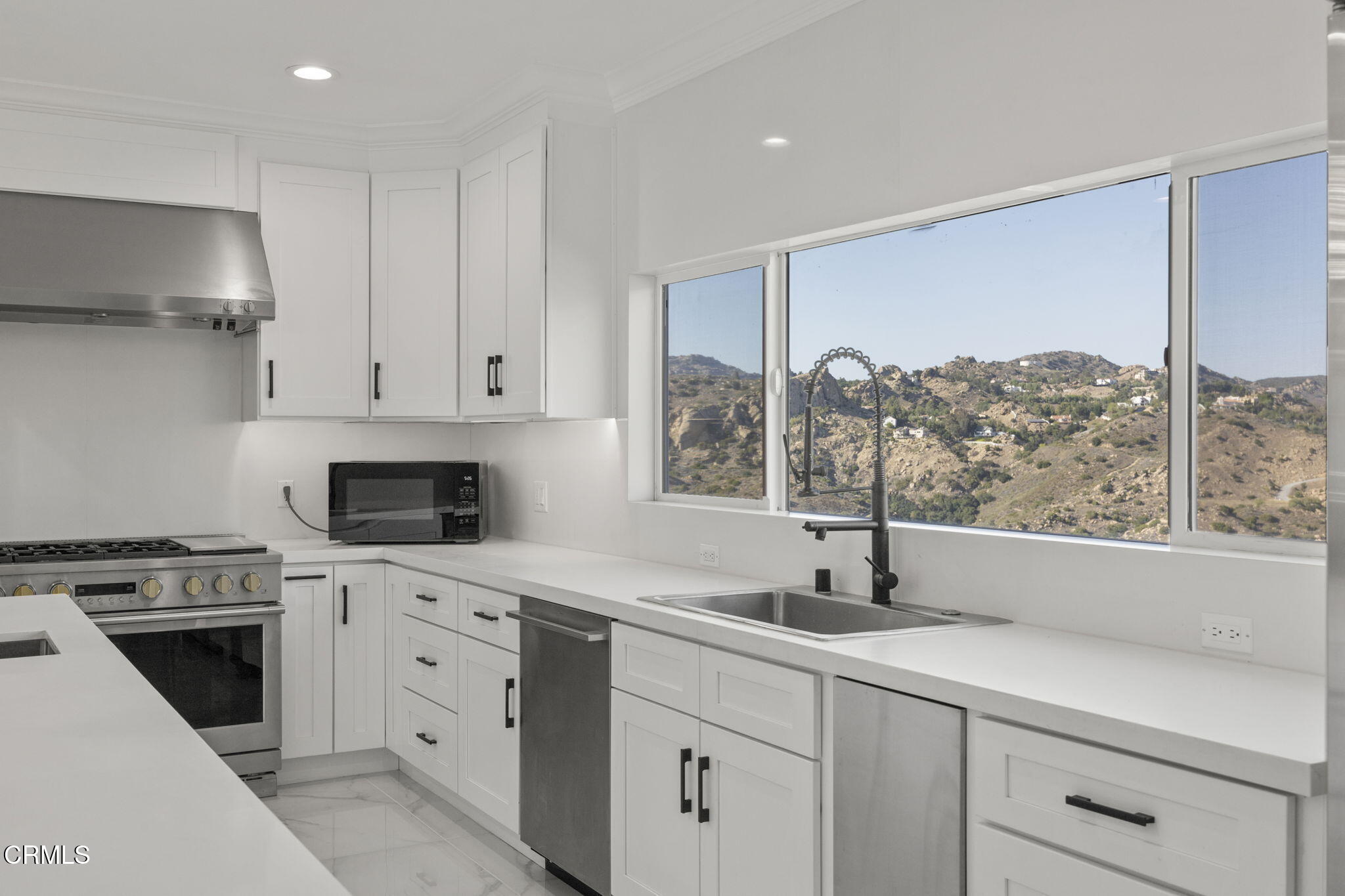 40 Saddlebow Road Bell Canyon, CA 91307 - Photo 23 of 70 a kitchen with stainless steel appliances a sink stove and cabinets