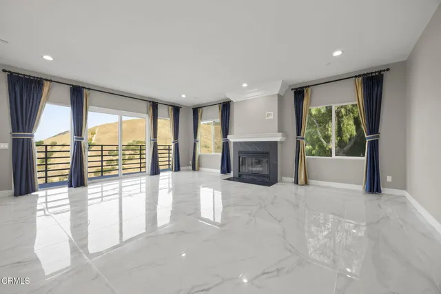 a view of walk in closet with wooden floor and fan