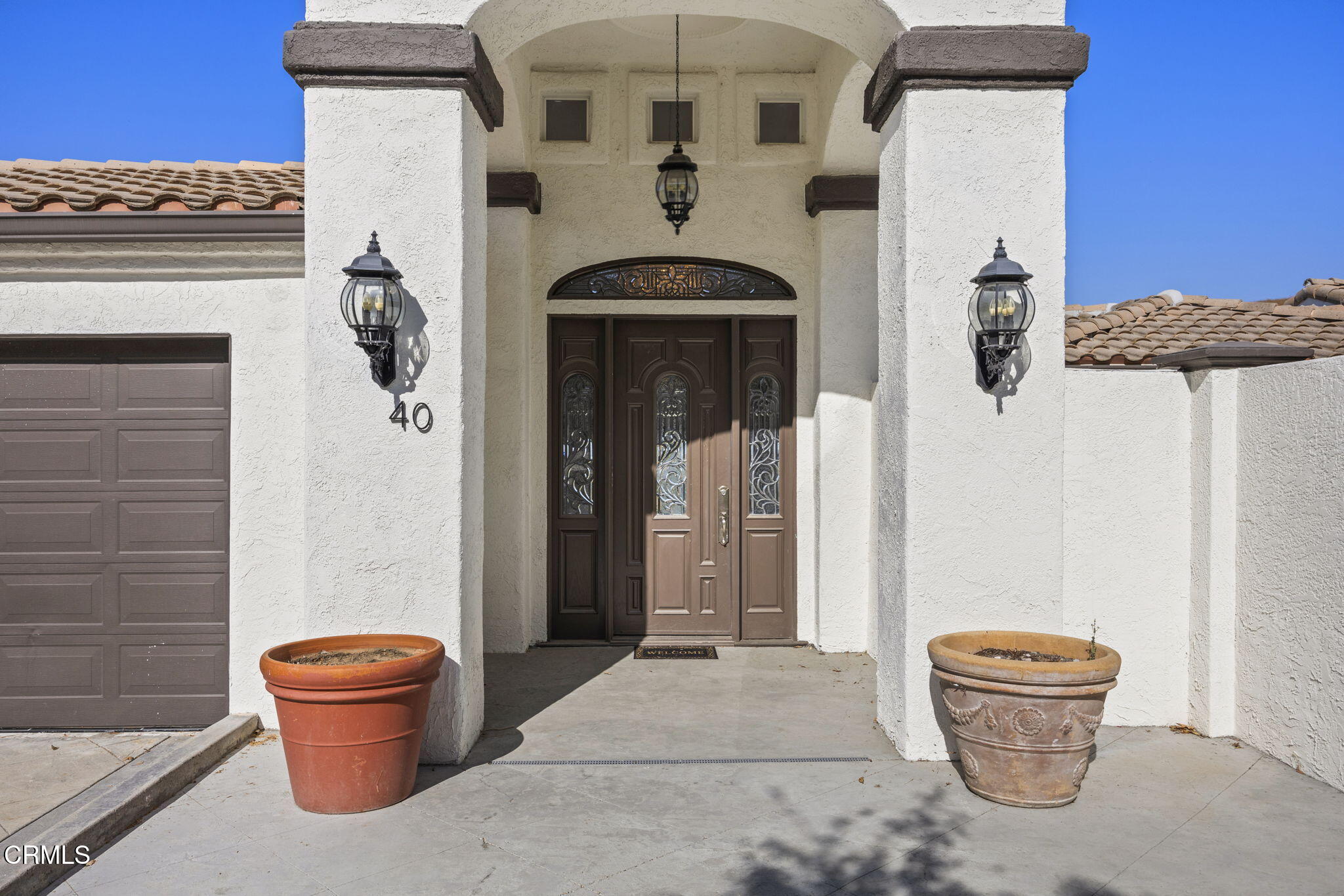 40 Saddlebow Road Bell Canyon, CA 91307 - Photo 3 of 70 a front view of a house with entryway and garage